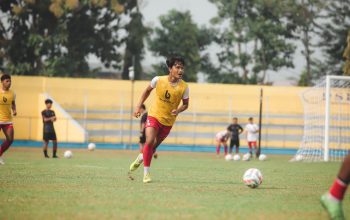 Pemain sepak bola yang energik saat sesi latihan di lapangan Jakarta.
