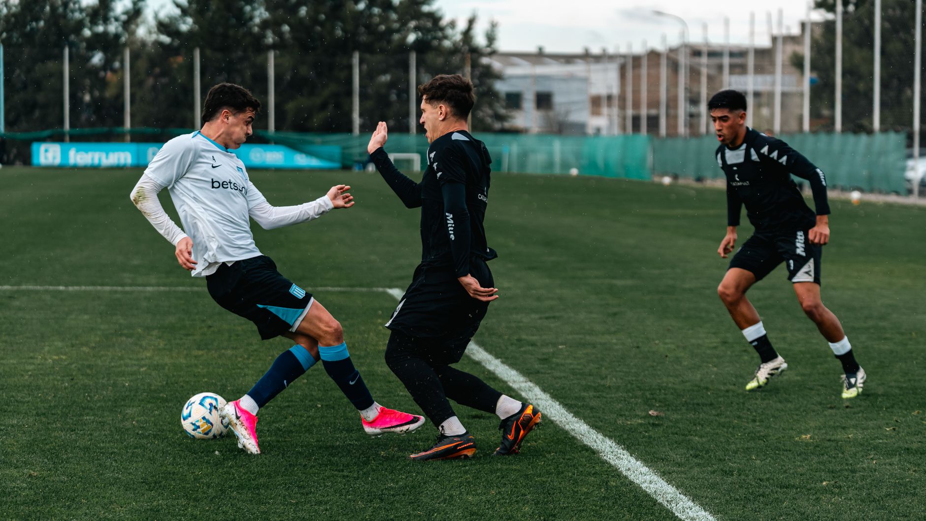 Latihan sepak bola berenergi tinggi dengan atlet muda yang berlatih di lapangan terbuka.